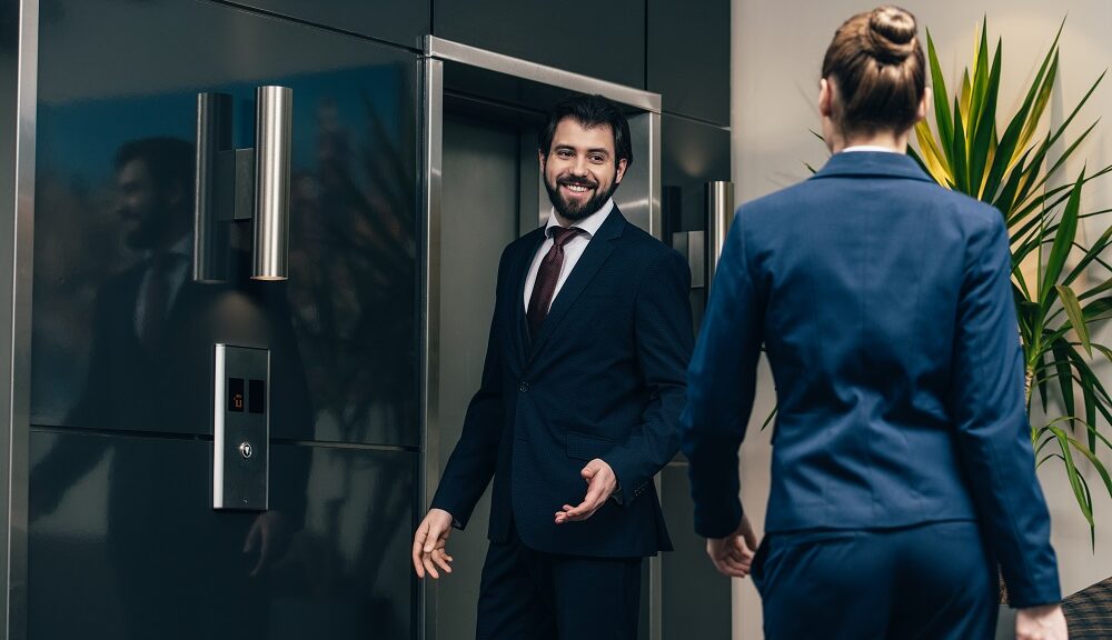 business people waiting for elevator together